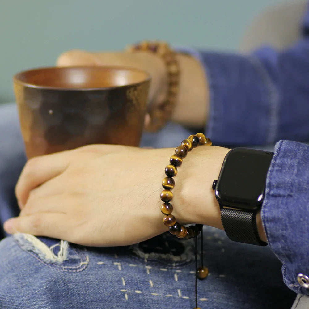 Wearing a yellow tiger eye bracelet and holding an exquisite ceramic coffee cup