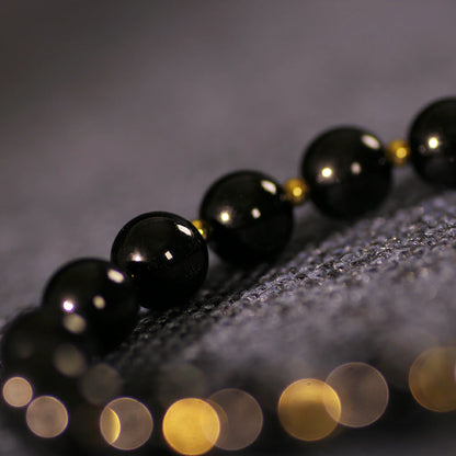 Obsidian Bracelet with Gold Accent Beads – Stylish Contrast