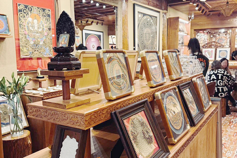 The display rack in the store displays traditional Nepalese hand-painted Buddhist thangkas